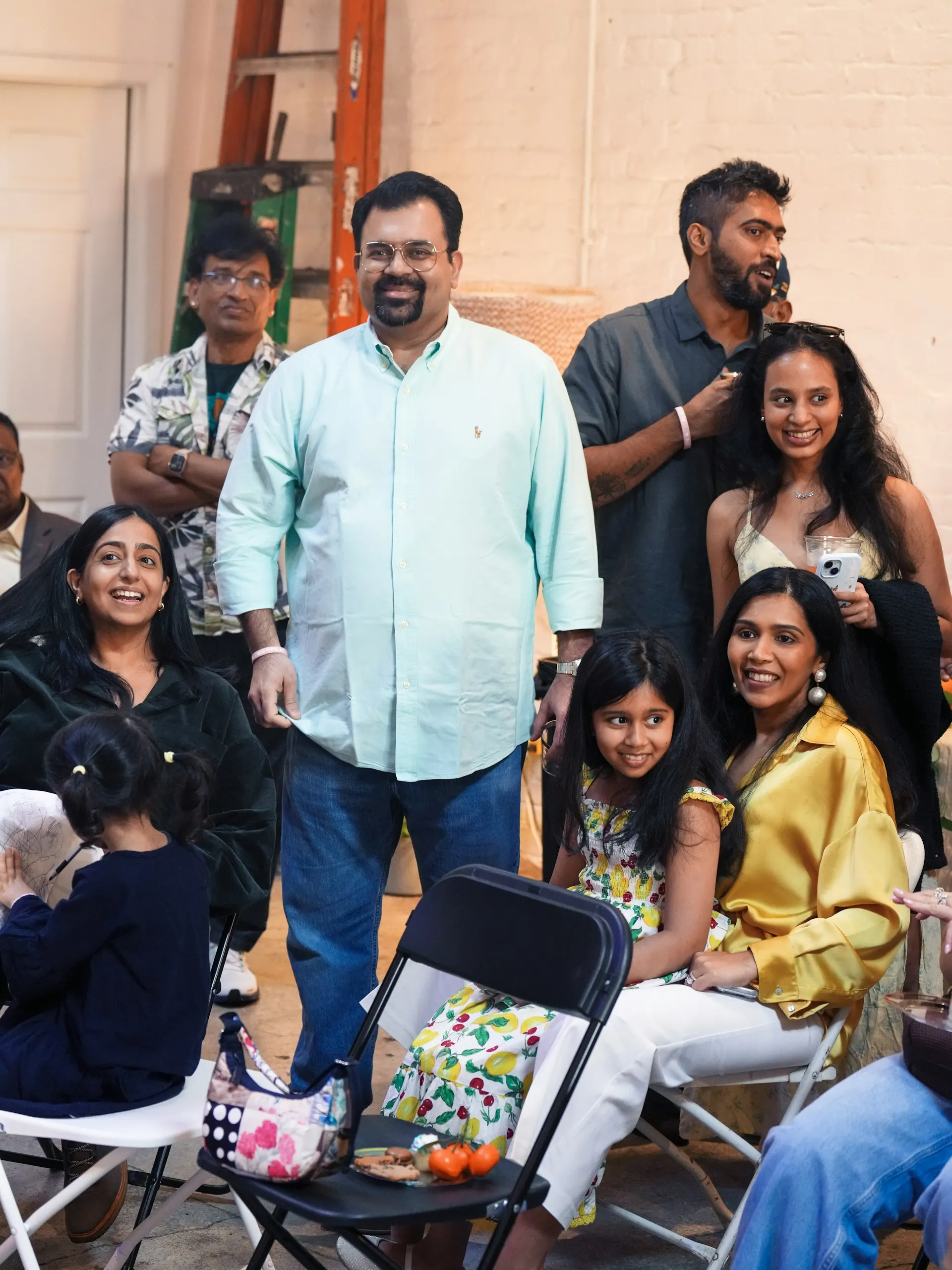 An Indian family gathered indoors for a joyful celebration.